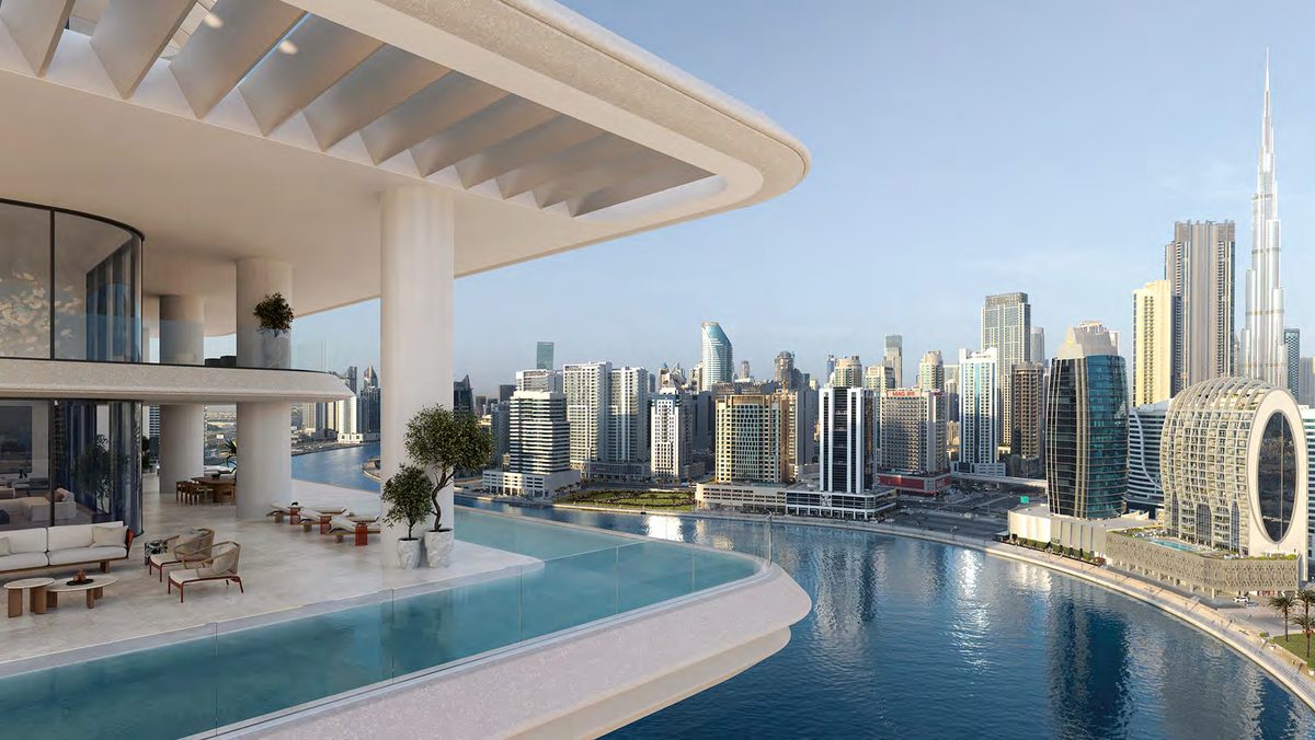 VELA, Dorchester Collection — living space opening to terrace pool and skyline